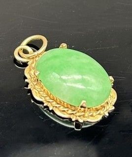 Pendant featuring an oval jadeite cabochon...