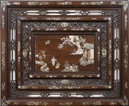 A double-framed, openwork carved wooden panel...