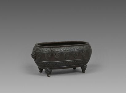 Four-legged bronze incense burner with a...