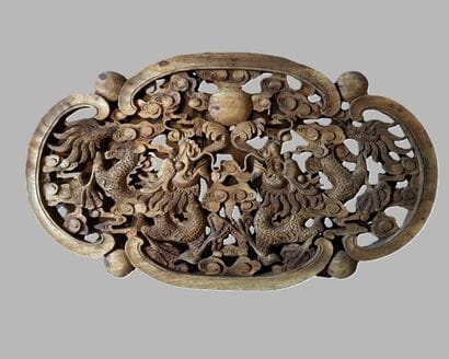 An oval-shaped decorative piece, carved and...