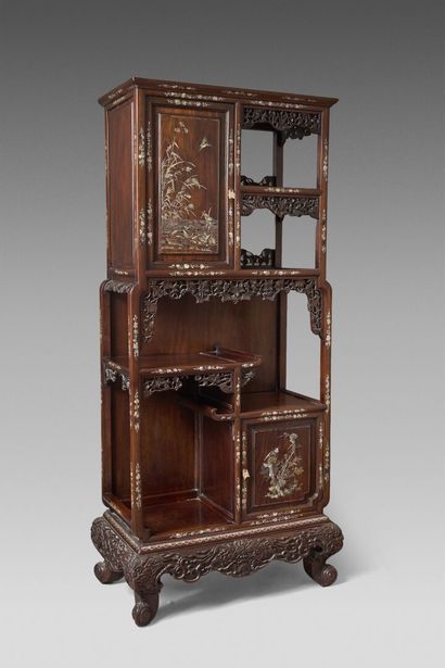 An elegant cabinet made of exotic wood, featuring...