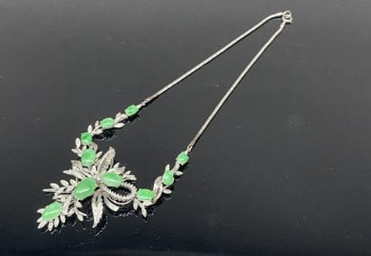 A draped metal necklace with a bamboo-style...