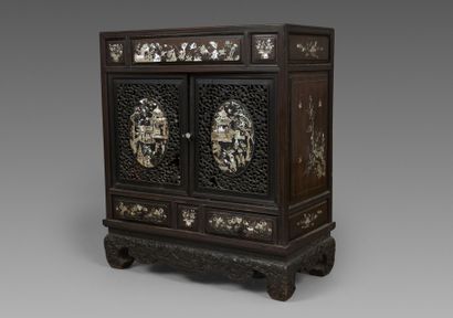 A small cabinet made of exotic wood, with...