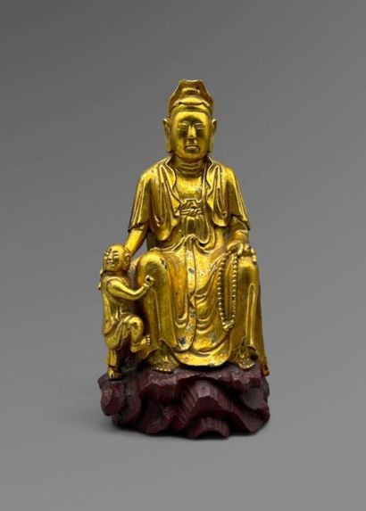 Red and gold lacquered wooden statue of Quan...
