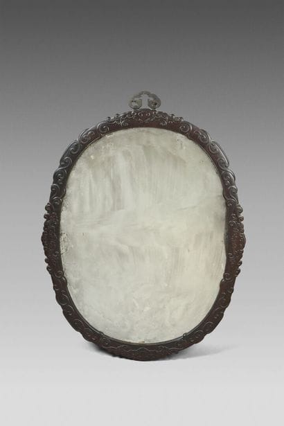 Large oval mirror in a frame of exotic wood...