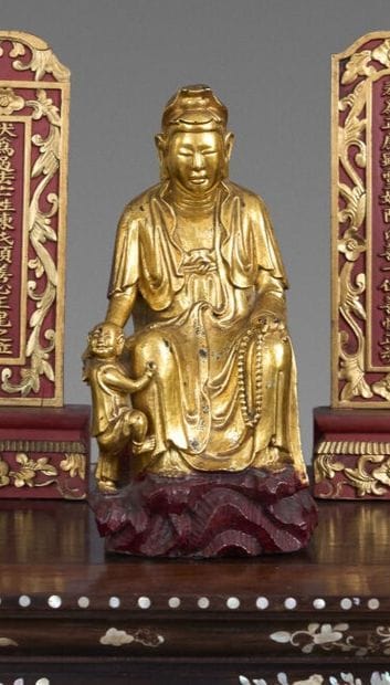 Red and gold lacquered wooden statue of Quan...