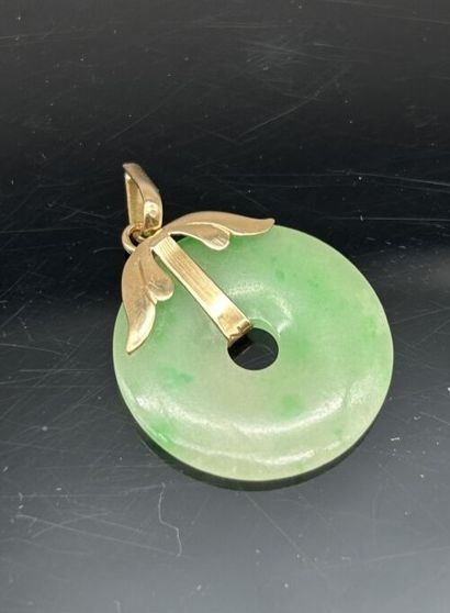 Pendant featuring an oval jadeite cabochon...