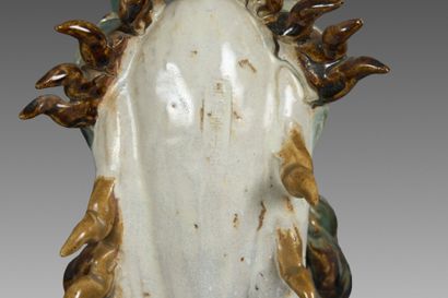 A partially glazed polychrome stoneware ridge...