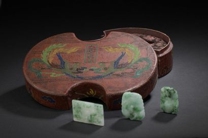Three jadeite pendants and their lacquered...
