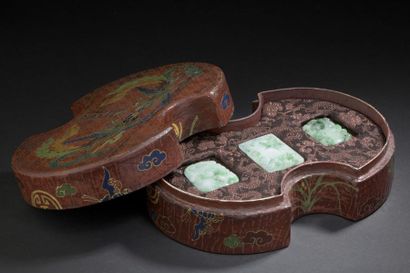 Three jadeite pendants and their lacquered...
