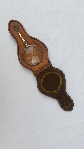 
Leather case containing a silver magnifying...