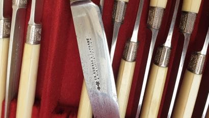 Set of cutlery in their cases (knives, salad...