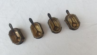 Four silver saltshakers and their shovels,...