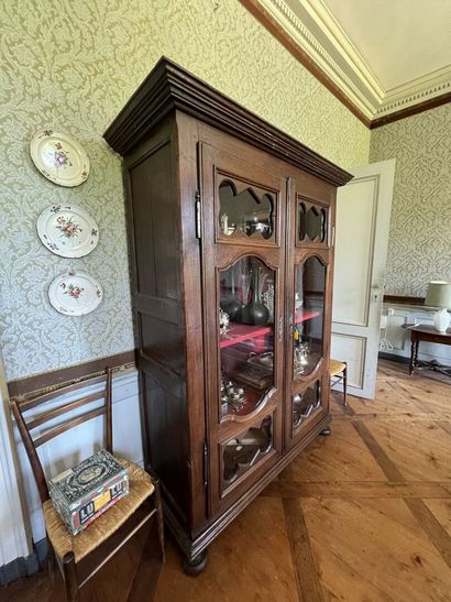 Glass cabinet in natural wood partly from...