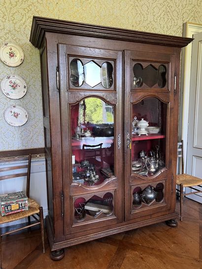 Glass cabinet in natural wood partly from...