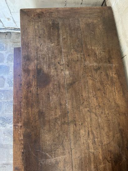 Large farm table in natural wood opening...