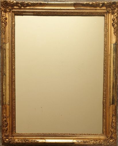 Glass in molded wood, carved and gilded,...