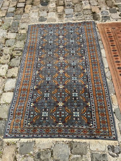 Two woolen carpets 

With geometrical decoration...