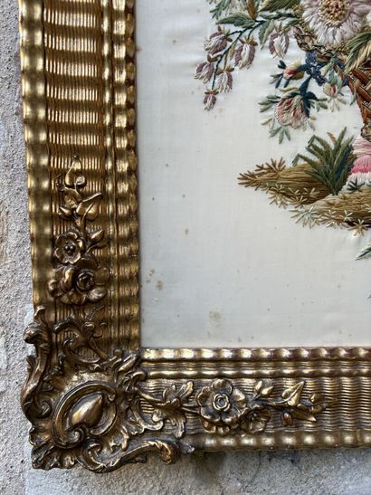 Embroidery on silk in a carved and gilded...
