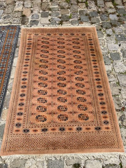 Two woolen carpets 

With geometrical decoration...