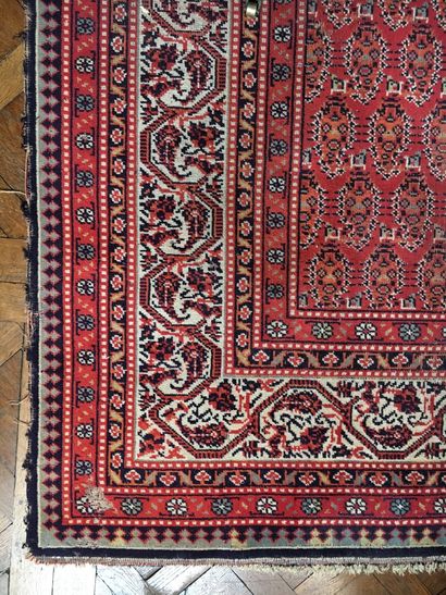Woolen carpet with red background decorated...