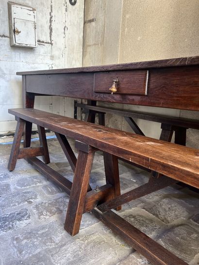 Large farm table in natural wood opening...