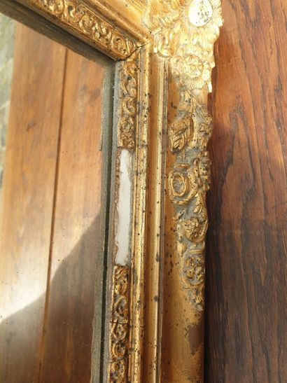 Glass in molded wood, carved and gilded,...