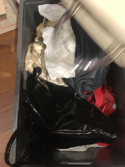 In a closet, a few handbags, some branded:...