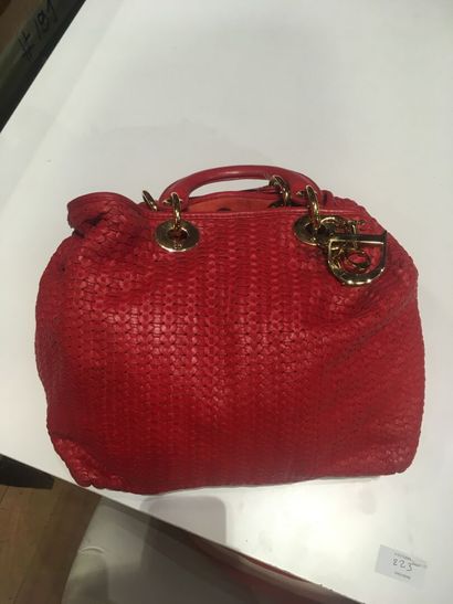 In a closet, a few handbags, some branded:...