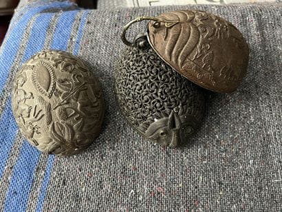 Three half carved coconuts, one mounted in...