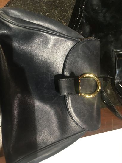 In a closet, a few handbags, some branded:...