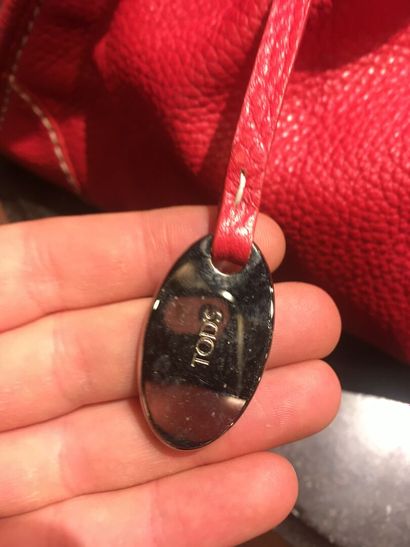 In a closet, a few handbags, some branded:...