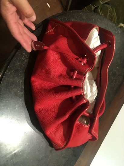 In a closet, a few handbags, some branded:...