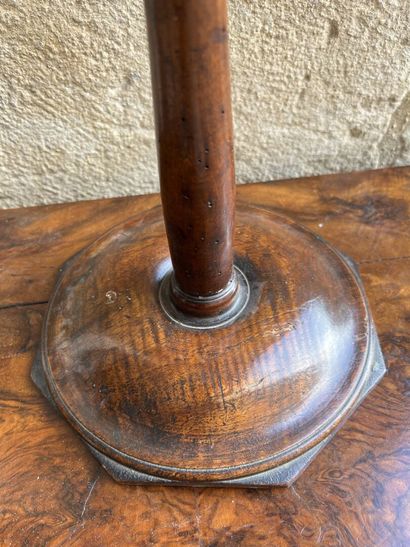 Magnifying glass on a natural wood pedestal,...