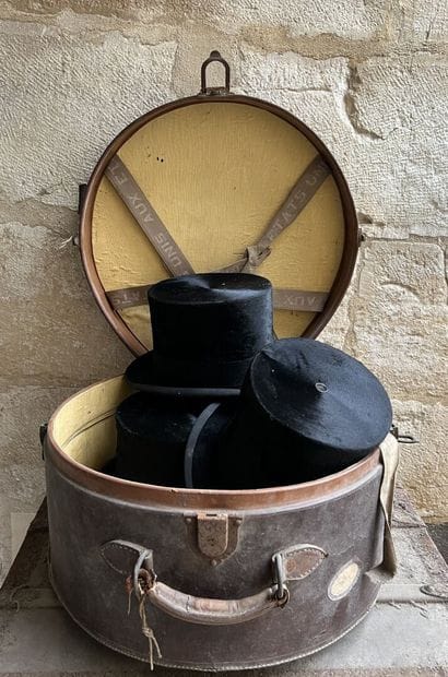 Three top hats contained in a hat case, circa...