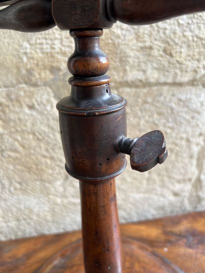 Magnifying glass on a natural wood pedestal,...