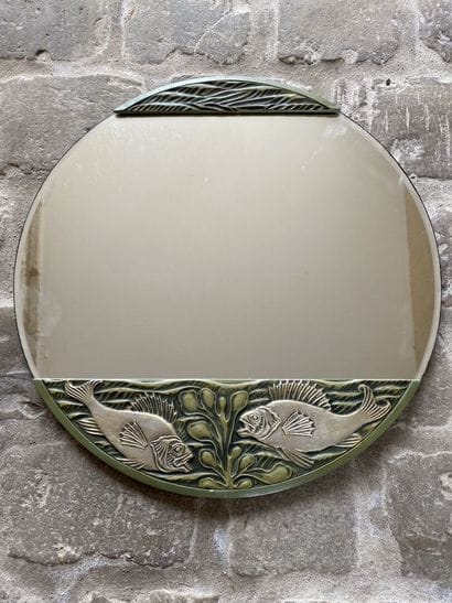 Circular glass decorated with two carved...