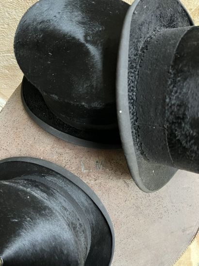 Three top hats contained in a hat case, circa...