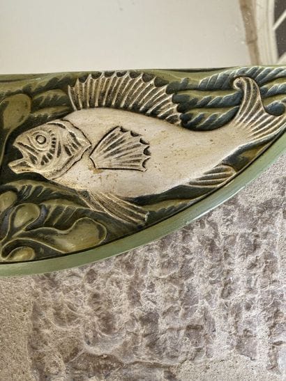 Circular glass decorated with two carved...