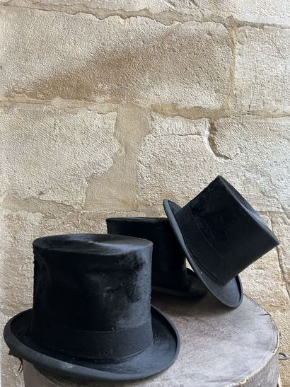 Three top hats contained in a hat case, circa...