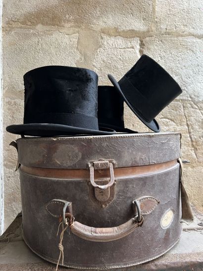Three top hats contained in a hat case, circa...