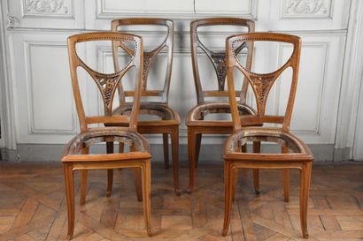 Suite of four molded and carved walnut chairs...
