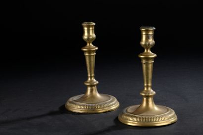 Pair of chased bronze candlesticks, formerly...