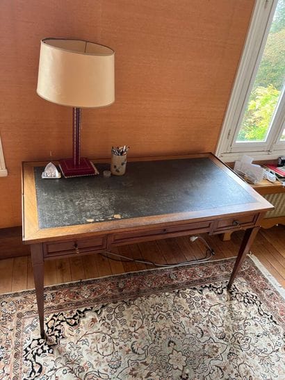 Writing table resting on four tapered legs...