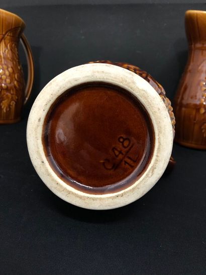 LOT of four barbotine pitchers including:
-...