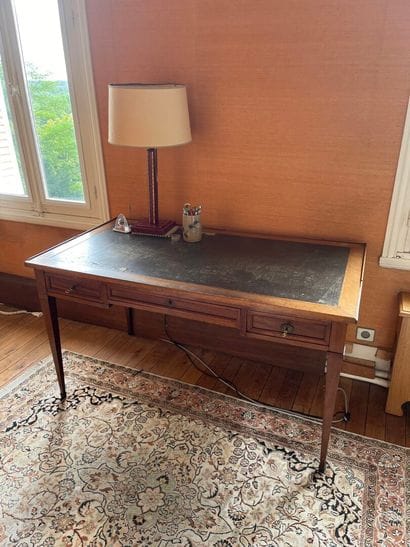 Writing table resting on four tapered legs...