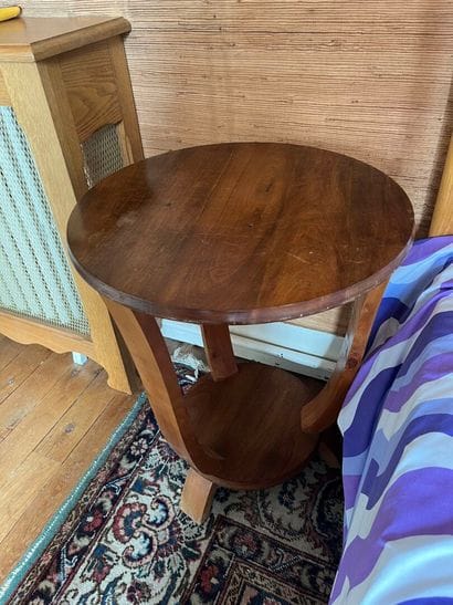 Round walnut bedside table with three legs...