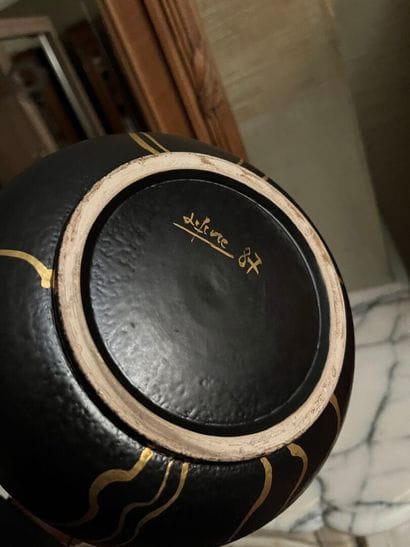VASE with long neck and rounded black body...
