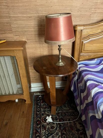 Round walnut bedside table with three legs...