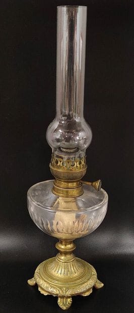 A kerosene lamp with fluted glass reservoir
Bronze...